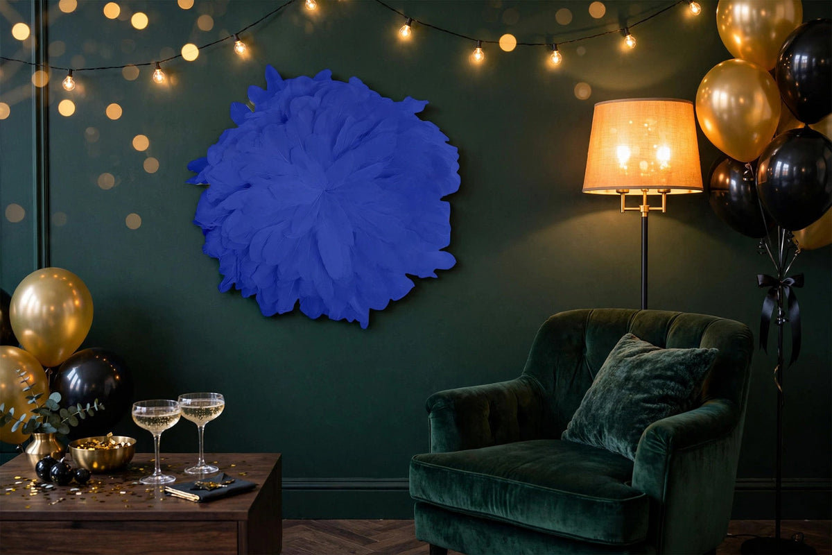 African JuJu Hats Feather Wall Art - Small - Navy hung on a wall in a holiday-decorated room