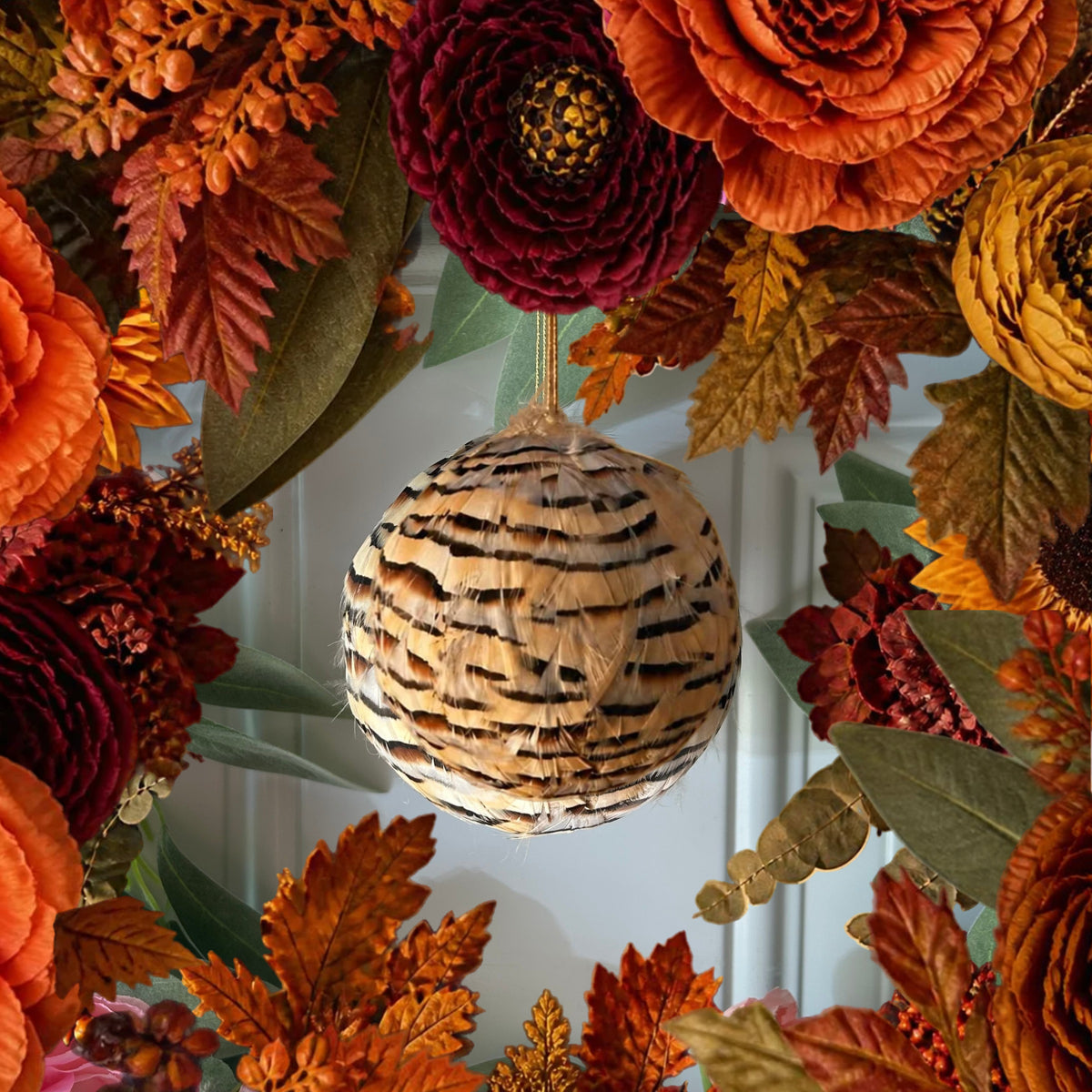 Natural partridge feather ornament 4" ball hanging on a fall wreath