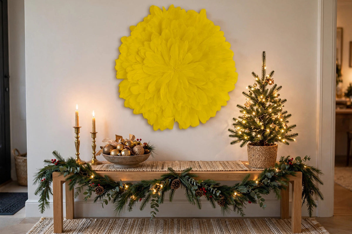 Unique Decorative Feather Wall Art Inspired by African JuJu Hats - Lemon Yellow hung on a wall in a holiday-decorated room
